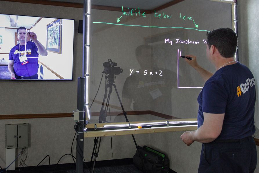person drawing on a lightboard