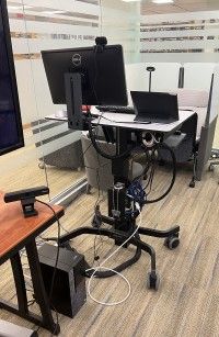 Instructor teaching station rear with PC, monitor, webcam, and control touchpanel
