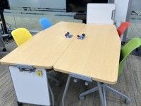Whiteboard standing on side at end of table