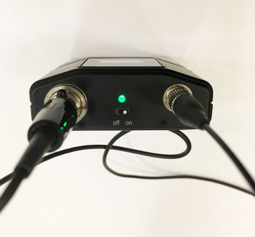 Top of mic pack shown with power switched on an illuminated LED